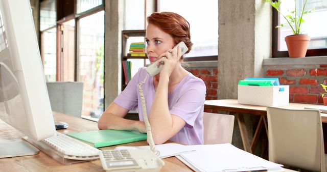 Casual caucasian businesswoman using computer on the phone, working in office, copy space - Download Free Stock Photos Pikwizard.com