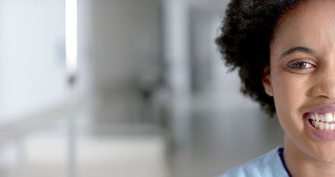 Smiling African American Nurse in Hospital Corridor Provides Comfort