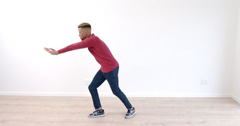 Young Man Perfecting Martial Arts Stance In Casual Wear