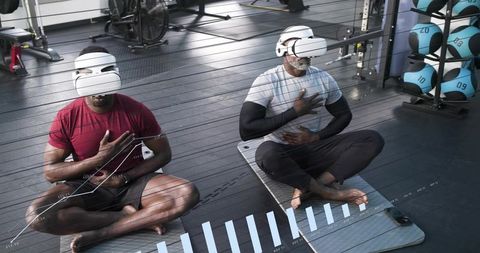 Immersive vr breathwork in gym, pair meditating with headsets practicing mindful breathing