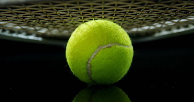 Close-Up of Tennis Ball Under Racket on Black Background - Download Free Stock Images Pikwizard.com