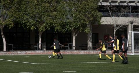 Dynamic Soccer Practice on Field with Goalkeeper and Team
