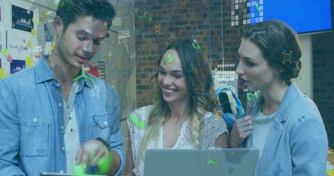 Young Team Collaborating with Augmented Reality Overlays on Laptop and Tablet