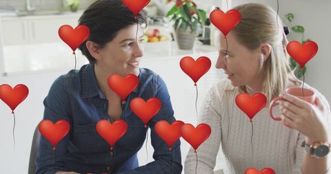 Romantic Couple Enjoying Coffee with Heart Balloons Overlay