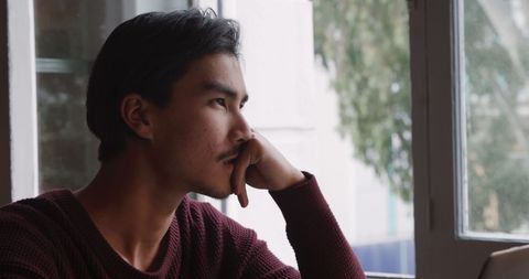 Thoughtful Young Man Contemplating by Window at Home - Download Free Stock Images Pikwizard.com