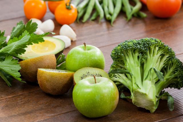 This image showcases a variety of fresh vegetables and fruits on a wooden table, emphasizing healthy eating and diet concepts. Ideal for use in articles, blogs, and websites focused on nutrition, organic food, and healthy lifestyle tips.
