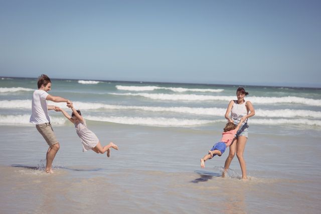 Happy family enjoying on shore at beach - Download Free Stock Photos Pikwizard.com