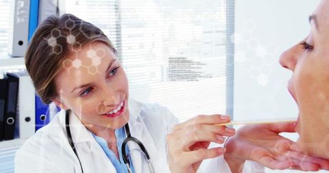 Healthcare Professional Using Tongue Depressor for Oral Examination