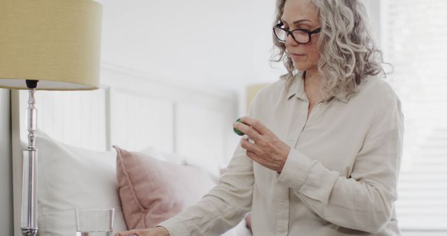 Senior Woman Taking Medication at Home with Water - Download Free Stock Images Pikwizard.com