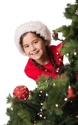 Happy girl in santa hat behind christmas tree transparent