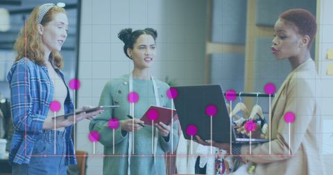 Diverse Business Team Analyzing Data Trends on Laptops