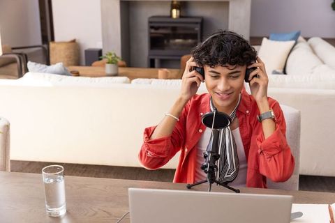 Man Performing Audio Recording in Home Studio