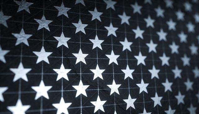 Repeating White Stars Tessellating Across Textured Black Fabric with Grid Seam Detail