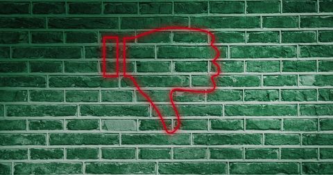 Red Neon Dislike Icon on Green Brick Wall - Download Free Stock Images Pikwizard.com