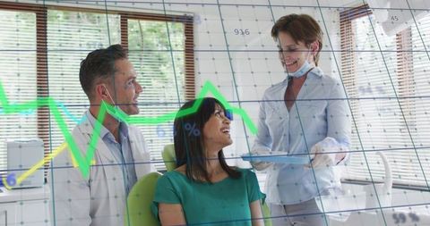 Dental team consulting smiling patient with digital data overlay in modern clinic