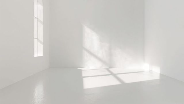 Sunlight pouring through window casting grid shadow on glossy white minimalist interior