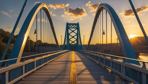 Blue steel arch bridge illuminated by golden sunset, knoxville concept