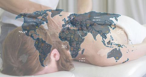 Therapist massaging client with global wellness map overlay concept for spa business