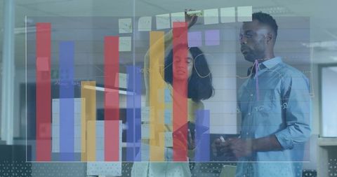 Colleagues Collaborating with Data Visuals in Modern Office