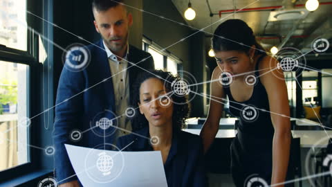 Team Analyzing Digital Network in Modern Office