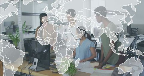 Women collaborating on global project plans at modern office desk with world map overlay