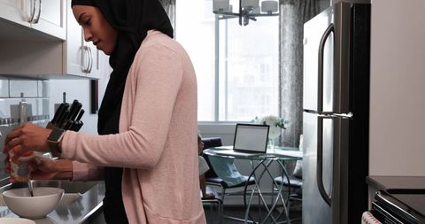 Hijabi Mother Cooking with Daughter in Bright Modern Kitchen