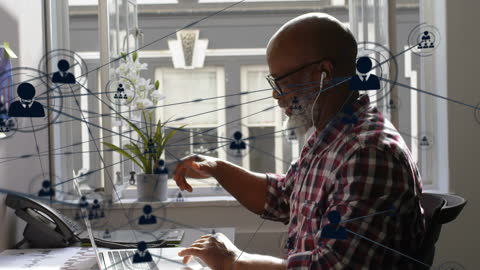 Businessman Connecting with Global Network on Laptop at Desk