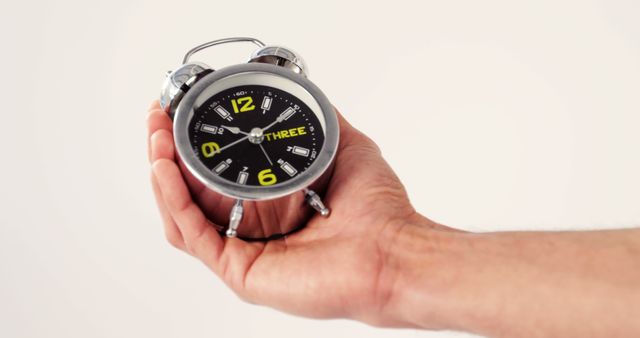 Hand Holding Small Metallic Alarm Clock - Download Free Stock Images Pikwizard.com