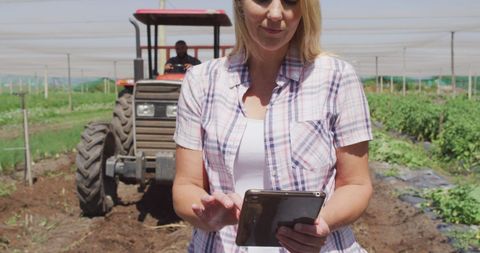 Caucasian woman using tablet on organic farm