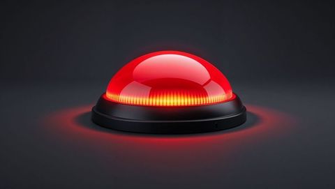 Futuristic red alert dome button emitting glow with black base