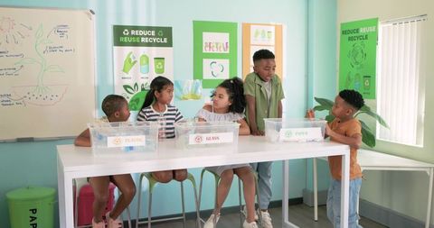 African american kids sorting recyclables, learning sustainability and teamwork