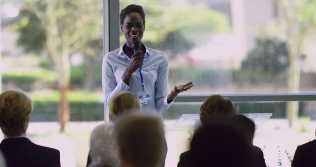 Confident Businesswoman Speaking at Conference with Microphone - Download Free Stock Images Pikwizard.com