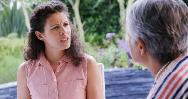 Concerned Woman Listening to Senior in Garden - Download Free Stock Images Pikwizard.com