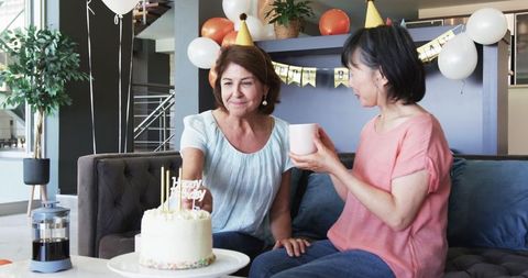 Senior Friends Enjoying Birthday Coffee Celebration at Home