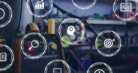 Yellow-Black Battery Charger in Workshop Showing Digital Diagnostics and UI Overlay