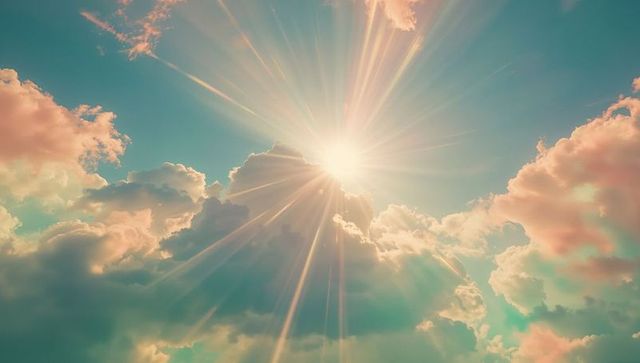 Radiant Sunlight Filtering Through Puffy Cumulus Clouds in Vibrant Sky