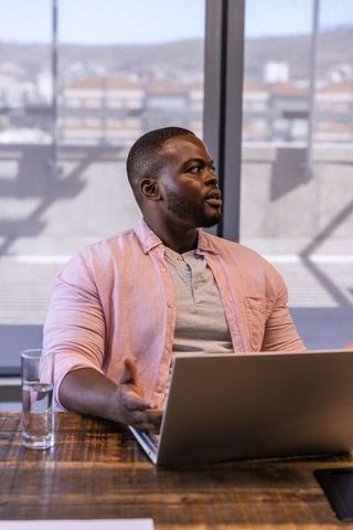 African American Professional Engaging in Office Meeting Discussion