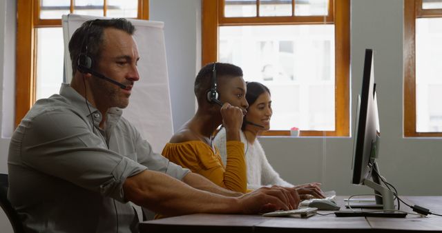 Customer Support Team Working at Desk with Headsets - Download Free Stock Images Pikwizard.com