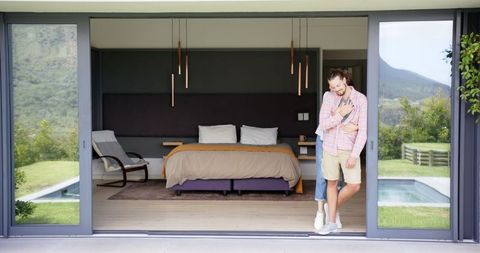 Man Relaxing by Open Patio Door Checking Smartphone - Download Free Stock Images Pikwizard.com