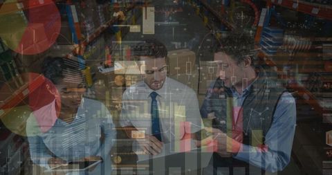 Diverse workers analyzing data in warehouse environment