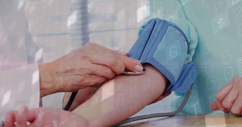 Doctor Monitoring Patient Blood Pressure in Clinic