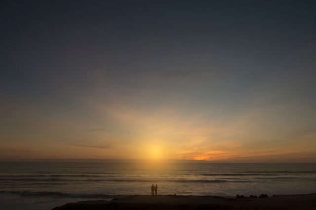 Couple Watching Romantic Sunset Over Ocean - Download Free Stock Images Pikwizard.com