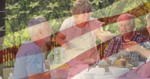 Elderly Friends Enjoying Picnic Under USA Flag Overlay