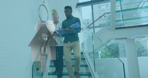 Collaborative Team Reviewing Notes with Holographic House Key Data