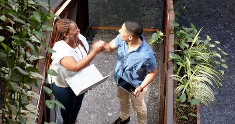 Joyful Business Partnership Between Multiracial Colleagues in Modern Office