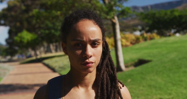 Confident Young Woman with Dreadlocks Outdoors in Urban Park - Download Free Stock Images Pikwizard.com