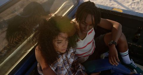Couple Relaxing in Back of Pickup Truck on Sunny Beach