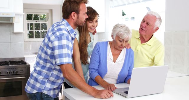 Family Helping Senior Woman with Laptop in Modern Kitchen - Download Free Stock Photos Pikwizard.com