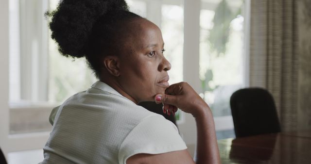 Thoughtful African American Woman Sitting at Table Near Window - Download Free Stock Images Pikwizard.com