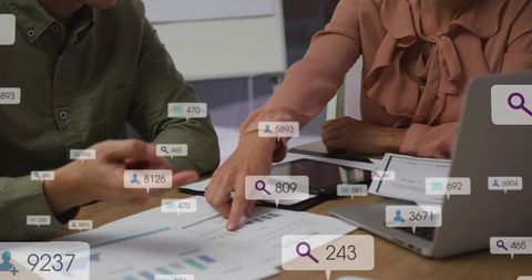 Business team reviewing data with augmented reality overlays pointing at analytics charts